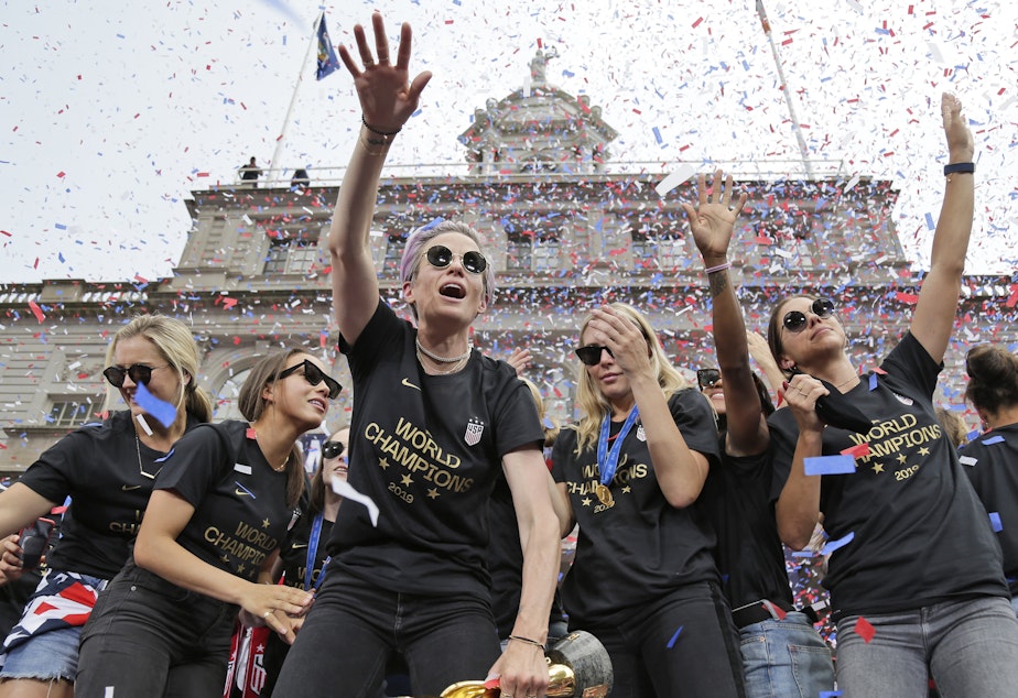 caption: Megan Rapinoe (center) and Alex Morgan (right), pictured celebrating with U.S. women's soccer teammates in New York after a ticker tape parade, on July 10, 2019. "We are pleased that the USWNT Players have fought for – and achieved – long overdue equal working conditions," a spokeswoman for the team said on Tuesday.