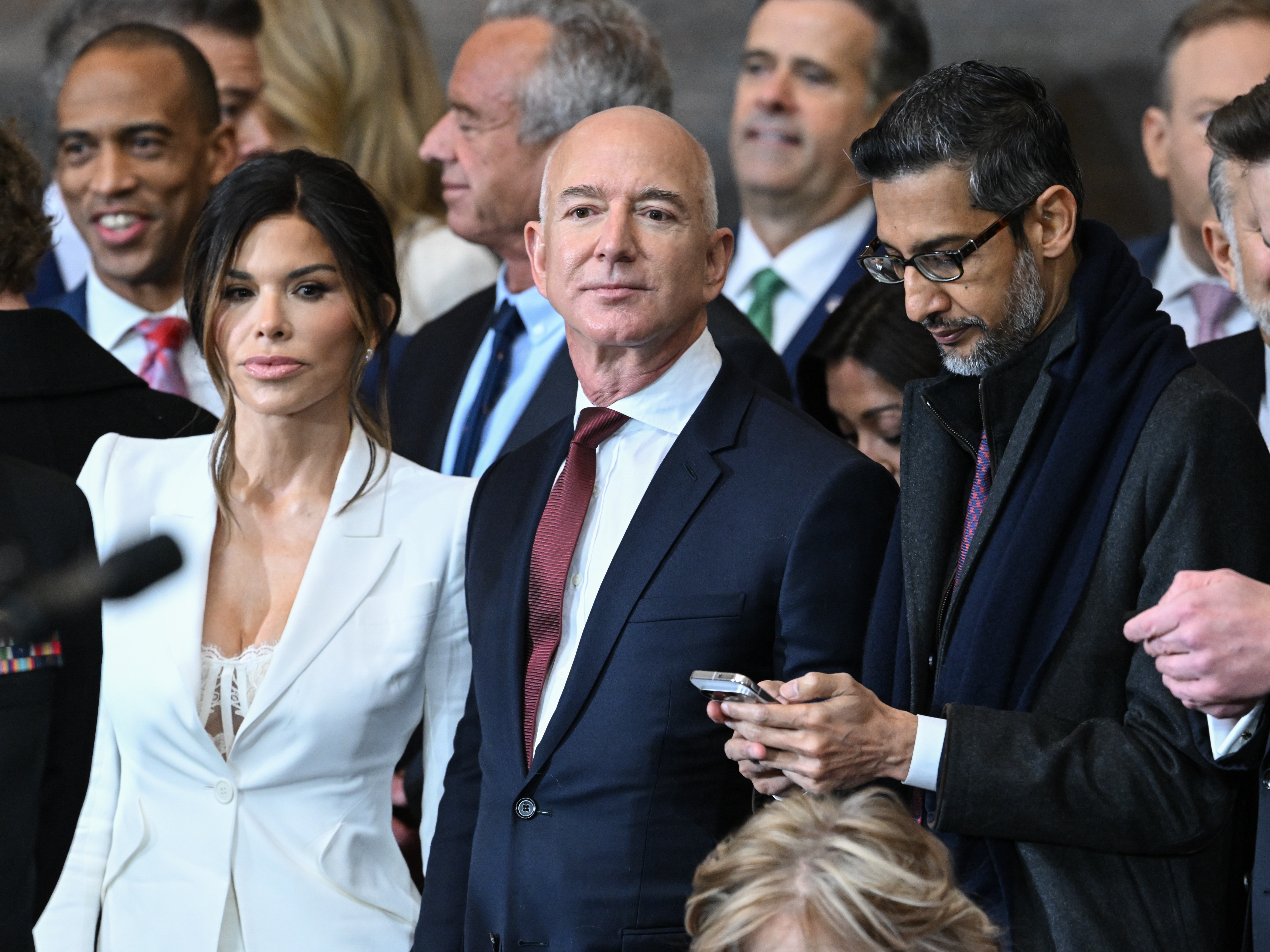 caption: <em>Washington Post </em>owner Jeff Bezos, center, shown at the inauguration ceremony of President Trump at the U.S. Capitol in January.