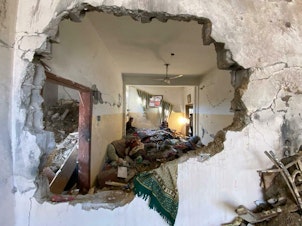 caption: More than 20,000 people have now been killed in Gaza since the start of the war, according to Gaza's Ministry of Health. Above, a home in Rafah is shown in the aftermath of an Israeli airstrike.