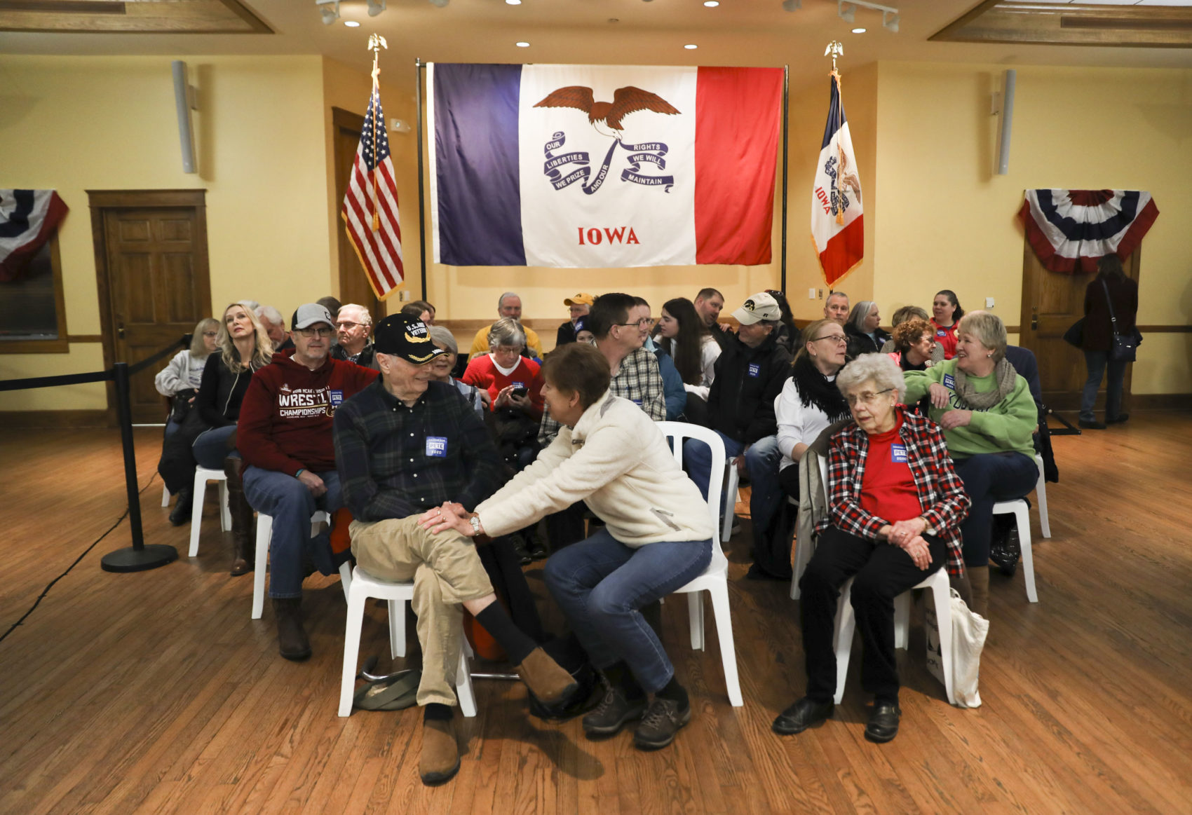 caption: Audience members wait for speakers to begin at a campaign event for Pete Buttigieg at The Music Man Square in Mason City, Iowa, on Wednesday, Jan. 29, 2020. (Rebecca F. Miller for Here & Now)