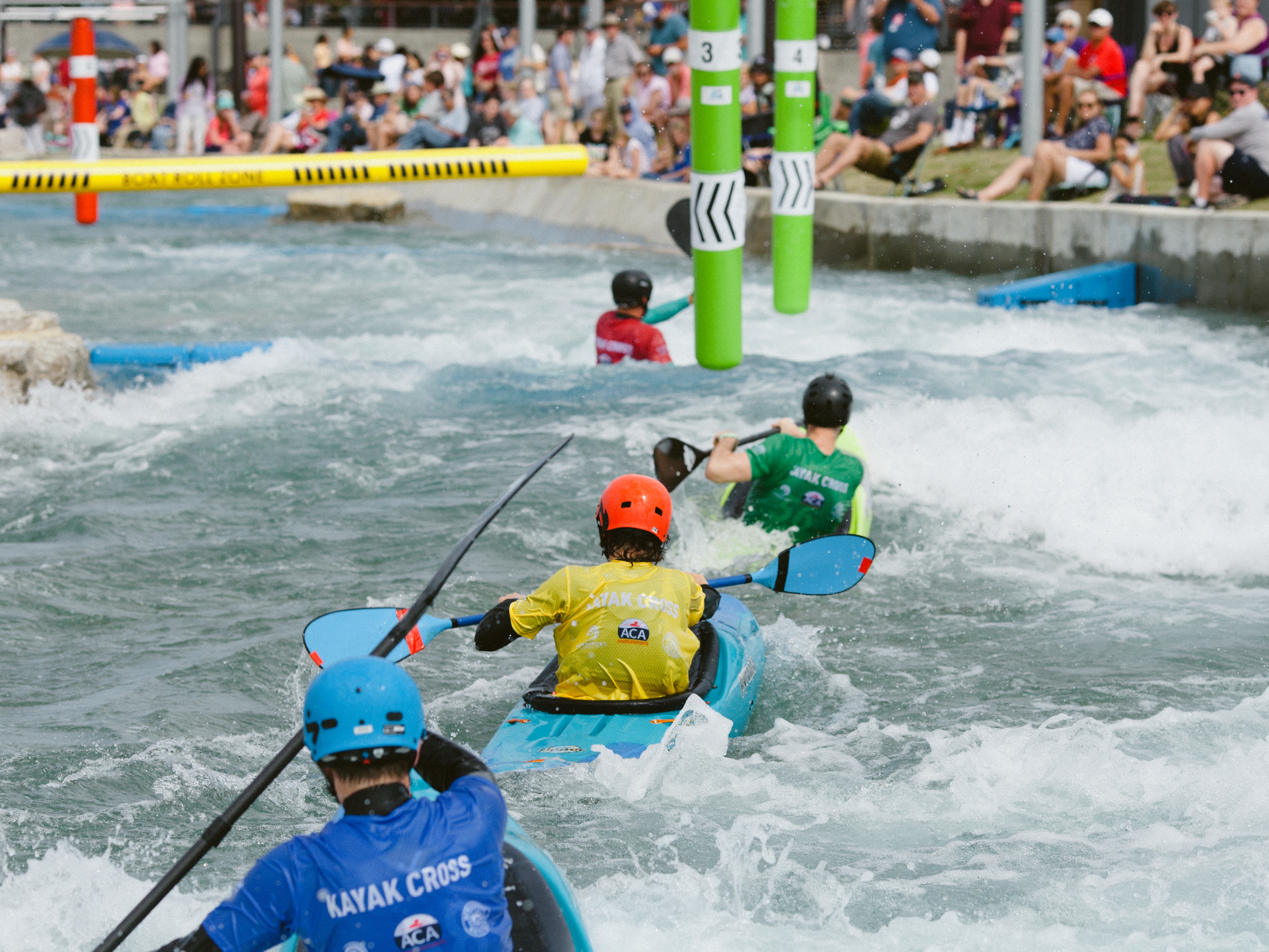 caption: Competitors at the U.S. canoe and kayak cross slalom trials in Montgomery, Ala. float through the coarse in April 2024. 