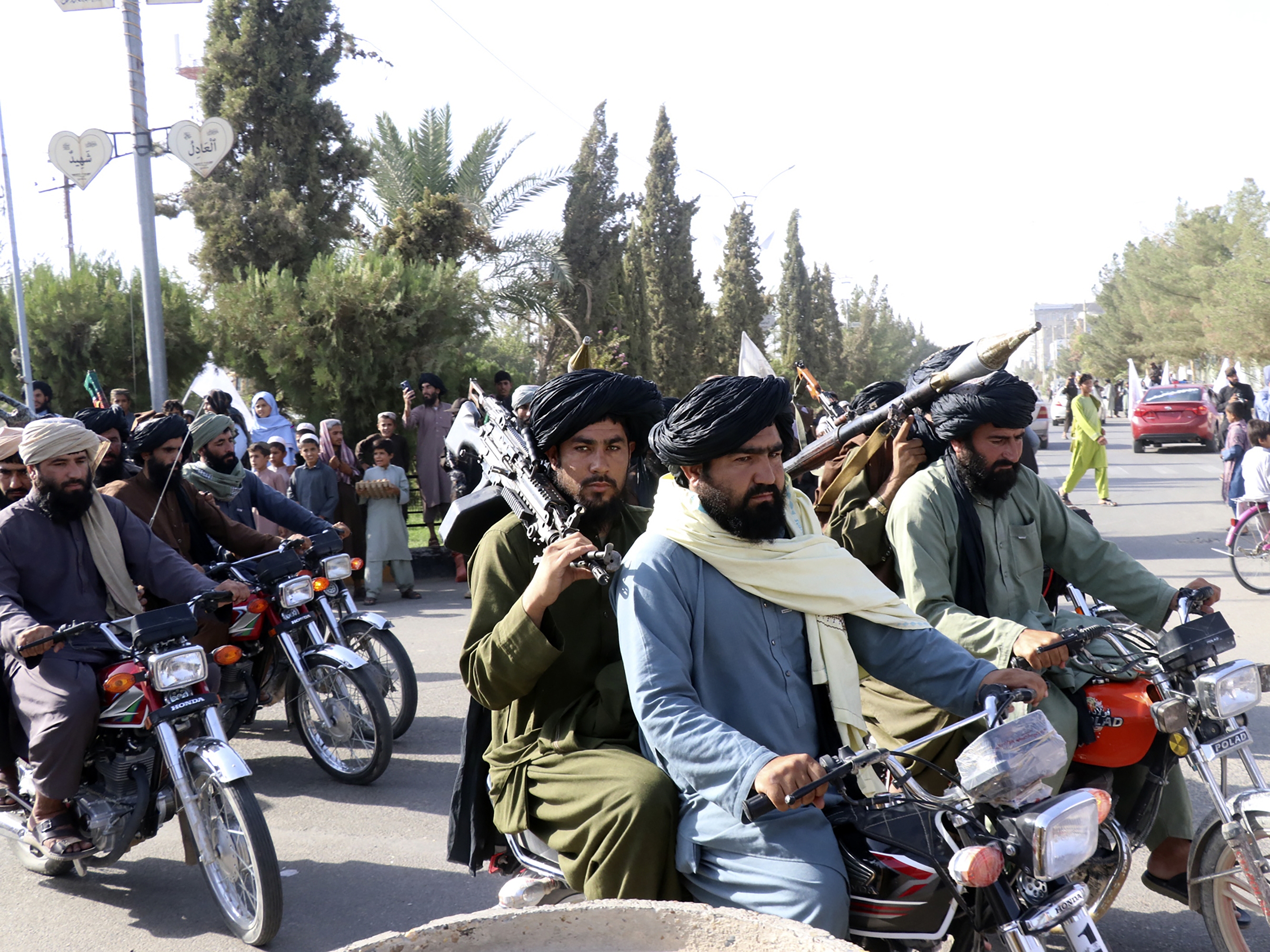 caption: Taliban fighters celebrate the third anniversary of the withdrawal of US-led troops from Afghanistan on Aug. 14, 2024.