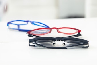 caption: Reading glasses are easy to come by in Western countries. But getting a pair in the Global South can be a challenge. A new study shows the surprising benefits that a pair of specs can bring.