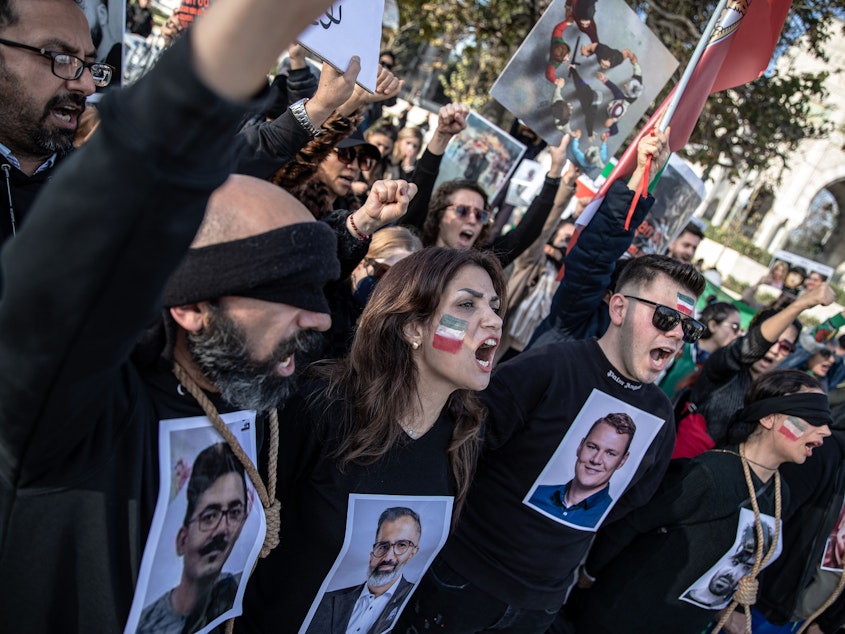 caption: People protest against the Iranian government at a demonstration in Istanbul, Turkey, on Saturday. In recognition of those allegedly executed by the Iranian government, protesters wore nooses around their necks and held photographs of people who have been killed.