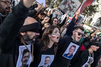 caption: People protest against the Iranian government at a demonstration in Istanbul, Turkey, on Saturday. In recognition of those allegedly executed by the Iranian government, protesters wore nooses around their necks and held photographs of people who have been killed.