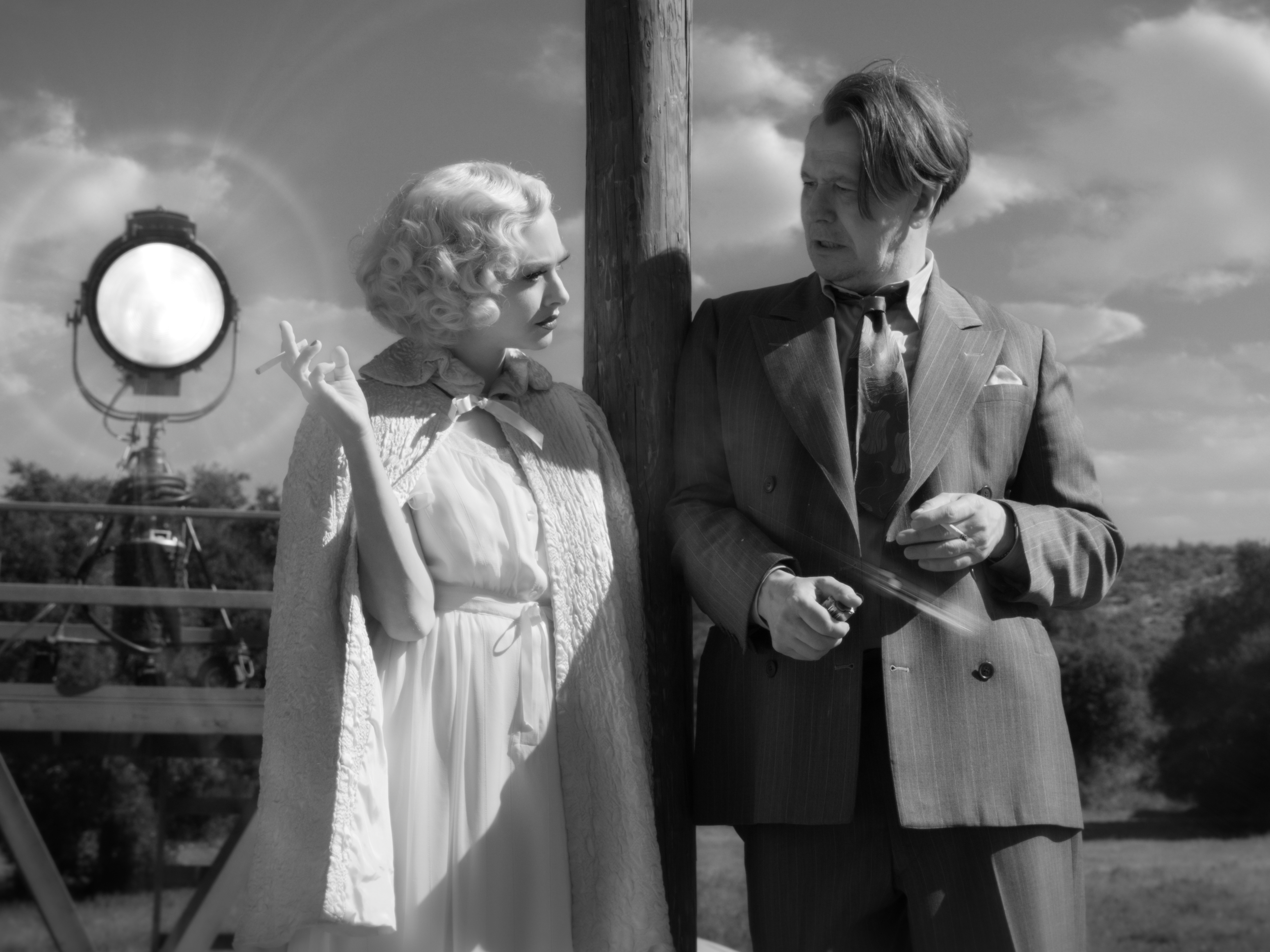 caption: Amanda Seyfried as Marion Davies and Gary Oldman in David Fincher's <em>Mank</em>, which led Monday's Oscar nominations.