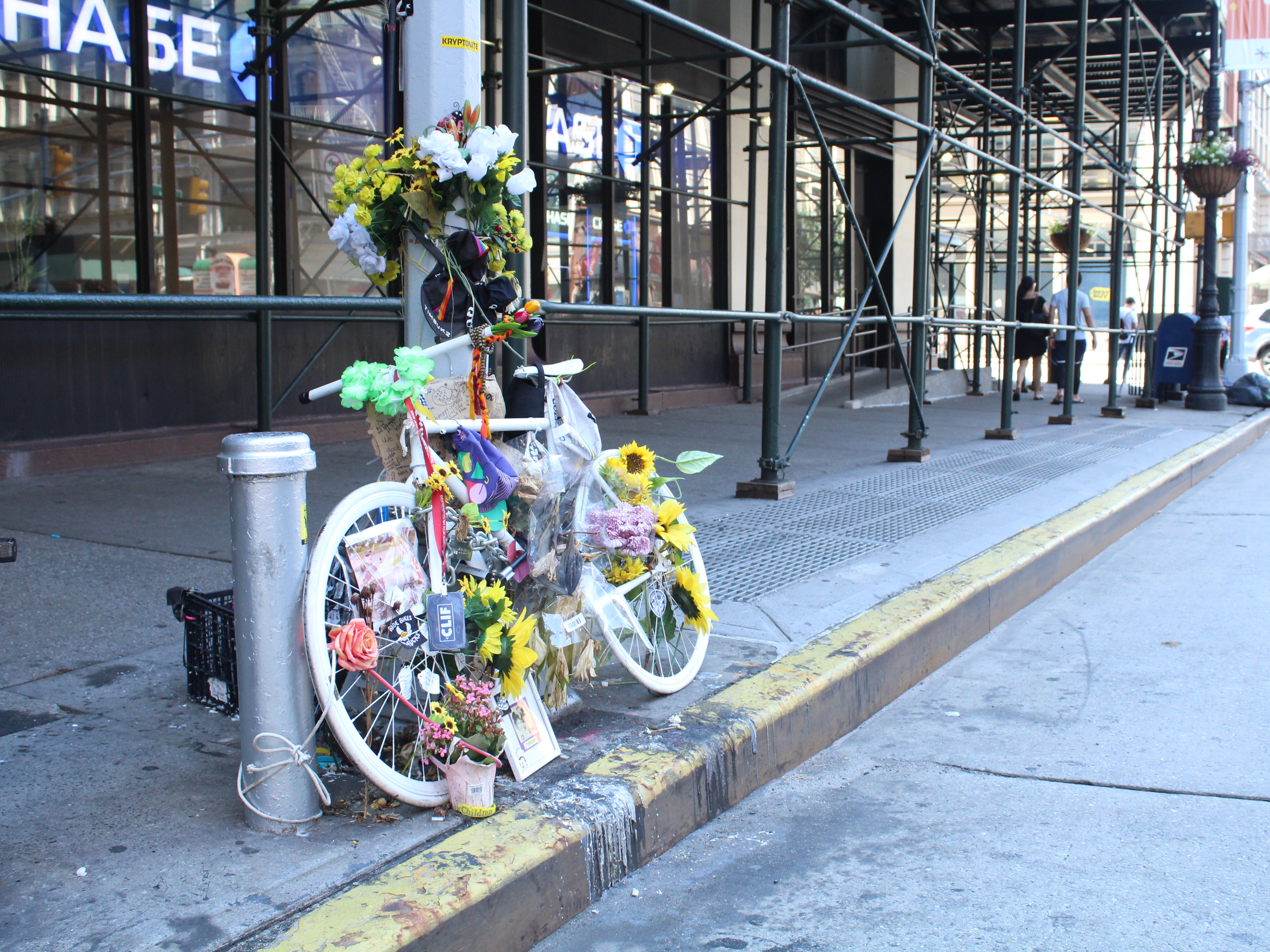 caption: Eight people have been killed in New York while riding their bikes since June, bringing the total number of deaths so far this year to 19. Above a memorial to one of the cyclists killed, Robyn Hightman.