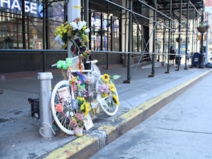 caption: Eight people have been killed in New York while riding their bikes since June, bringing the total number of deaths so far this year to 19. Above a memorial to one of the cyclists killed, Robyn Hightman.